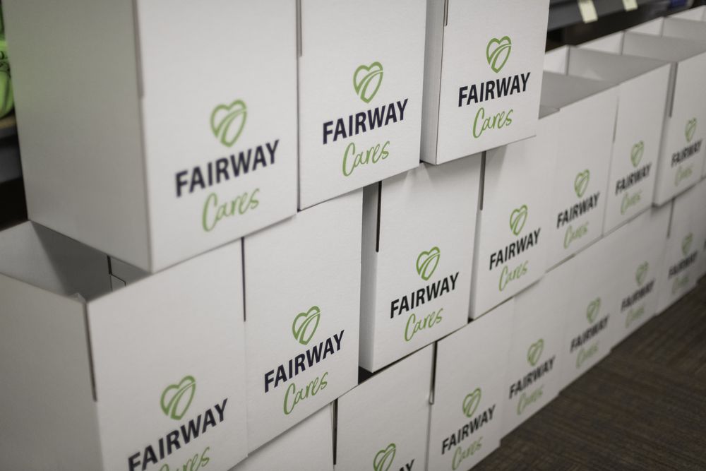 Stacks of white Fairway Cares care package boxes ready to ship