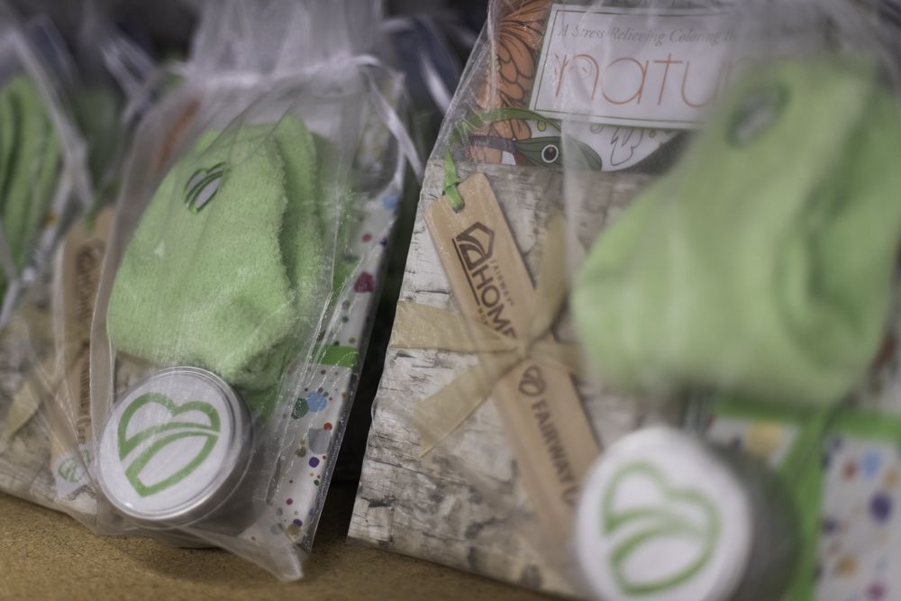 Hand-tied comfort gift bags with fuzzy socks and a stress-relieving coloring book
