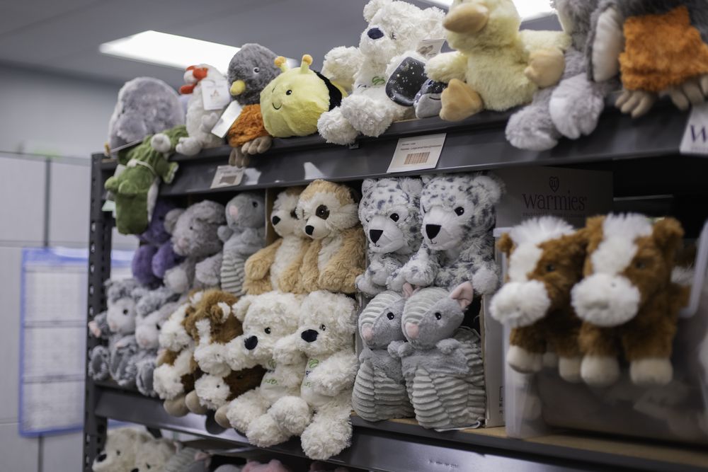 Shelves of plush comfort animals in the Fairway Cares packing room